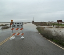 image of road closed sign on a flooded road