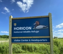 blue entrance sign with redheaded duck drawing at horicon national wildlife refuge visitor center