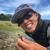 person smiling and holding a small toad 