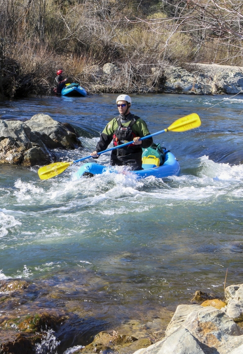 a person kayaking in rapids