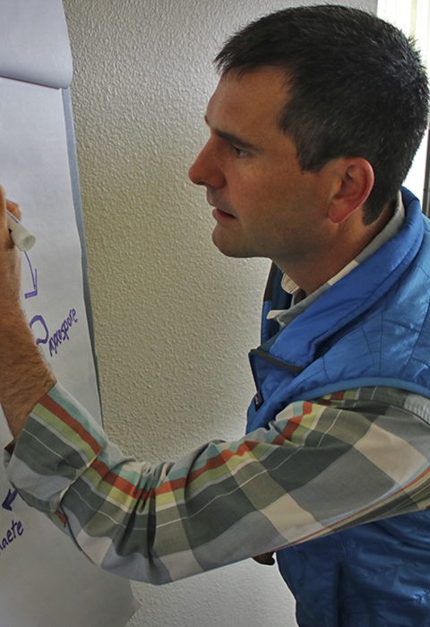 A man writes on a poster board