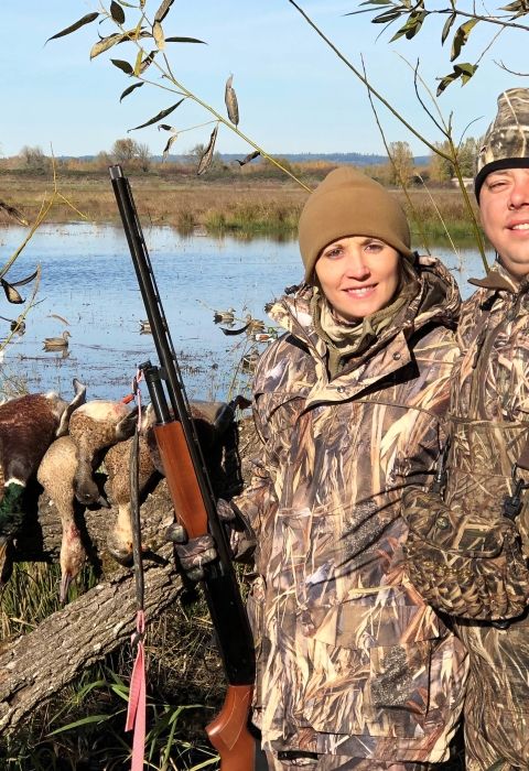 Man and woman waterfowl hunting
