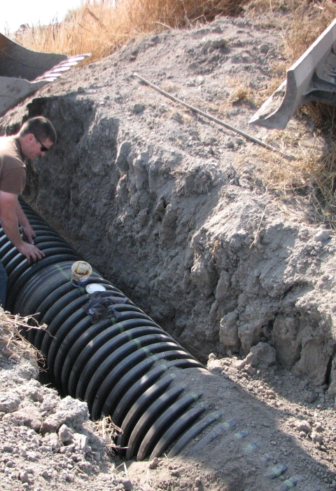 FWS Staff Installing Drain Pipe at Tule Lake NWR