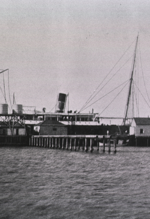 And old black and white photo of a ship and Blackbeard wharf.