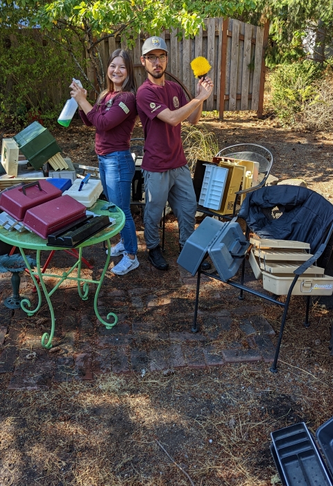 Service interns pose with cleaning gear and over 20 used tackle boxes they cleaned out.