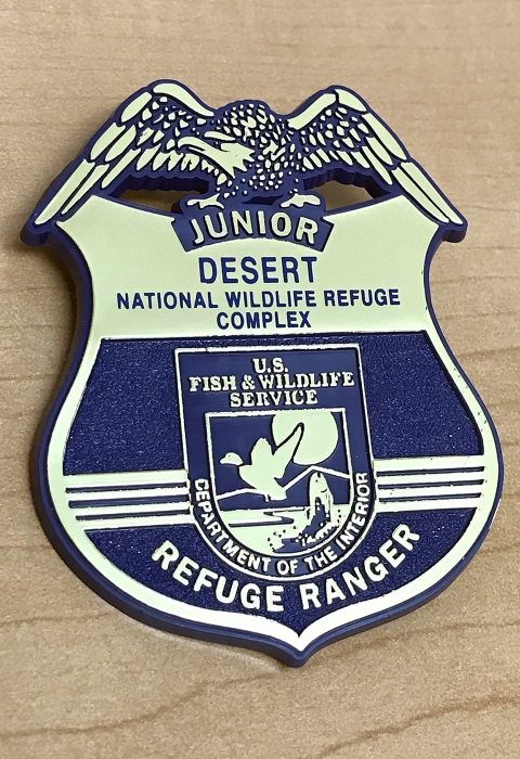 Blue and gold badge depicting the FWS logo and Junior Refuge Ranger