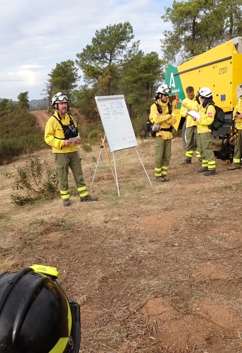 firefighters in circle around whiteboard