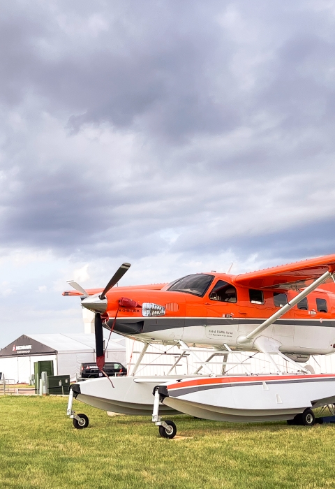 Migratory Bird Program Daher Kodiak survey plane in front of the International Federal Pavilion at EAA AirVenture convention
