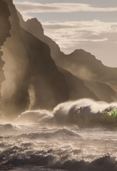 Waves crash against the coastline on Kauai