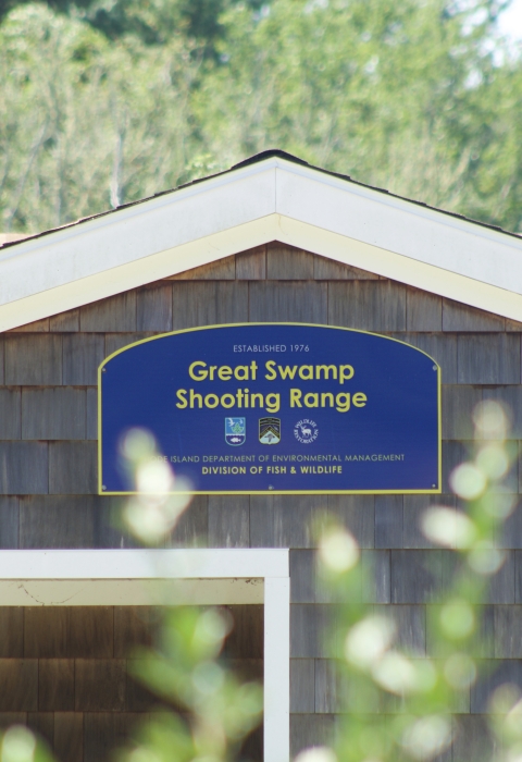 Blue welcome sign at over the shooting range