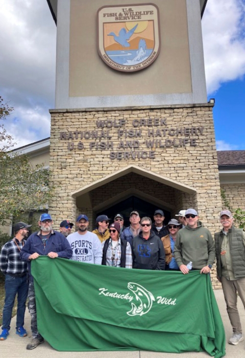 Group posing with banner