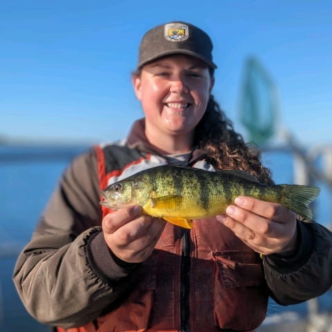 employee holding a fish