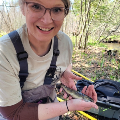 employee holding a fish