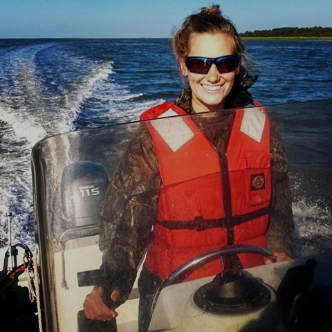 Profile photo: Samantha Apgar driving a boat.