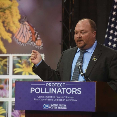 Chuck Traxler speaks at a protect pollinators event with the U.S. Postal Service