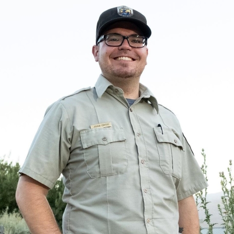 Park ranger in a tan uniform and brown hat