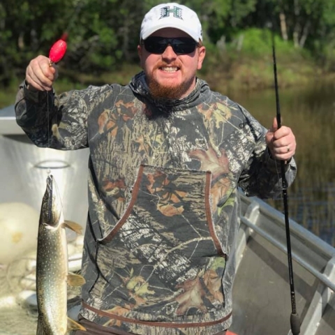 Gary Decosas shows his catch after fishing