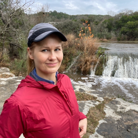 Selfie of Dr. Donelle Robinson standing in front of Bull Creek on a partly cloudy day