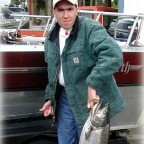 Todd Gilmore holding a salmonid