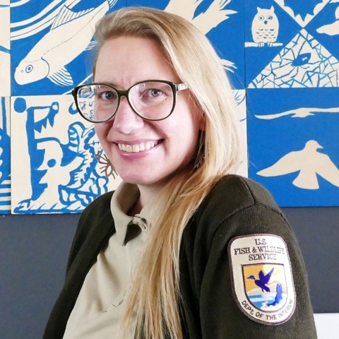 A portrait of a woman in a U.S. Fish and Wildlife Service uniform