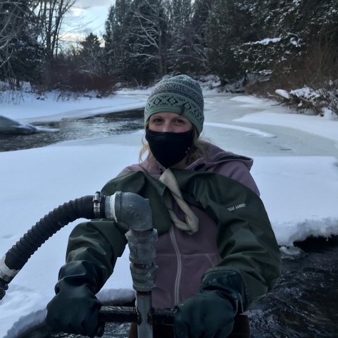 Kirstin Underwood stocking eggs in stream.