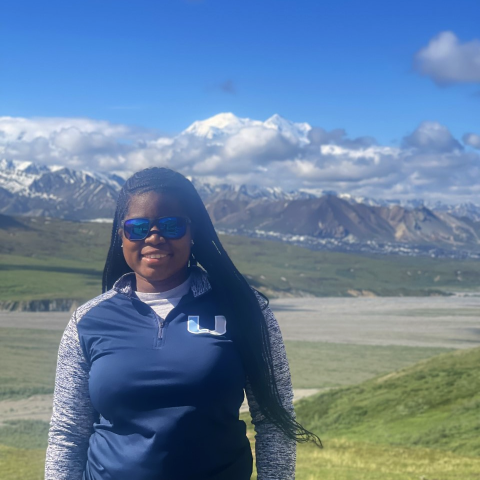 woman standing in front of mountains