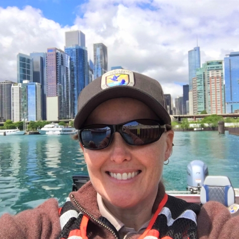 Woman smiling on boat in the Chicago river.