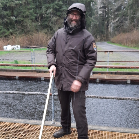 Quinault National Fish Hatchery Assistant Project Leader, Samuel Van Liew, cleaning fish rearing ponds