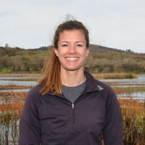 Sarah Markegard smiles surrounded by a wetland landscape.