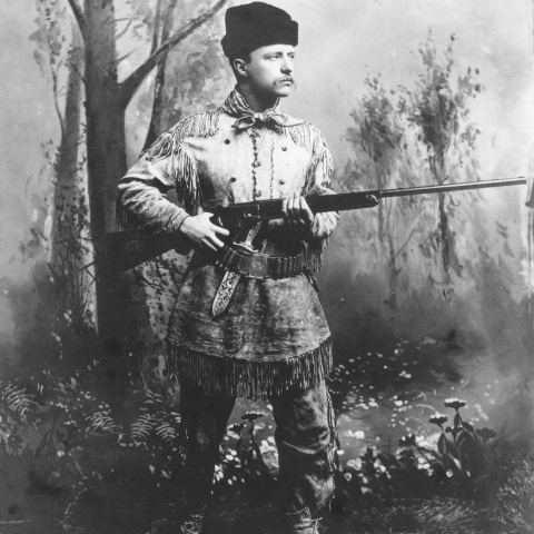 man standing with rifle in hands