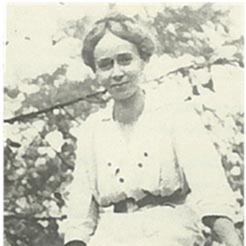 woman smiling sitting on tree branch