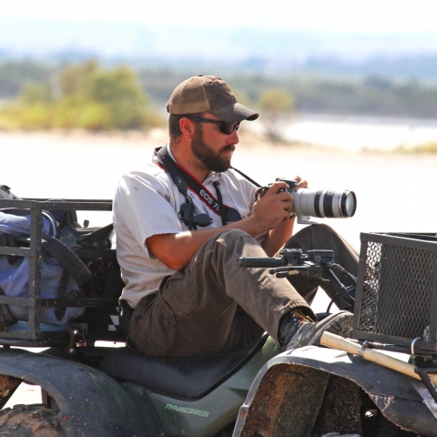 Wildlife biologist Glen Hensley setting on ATV during shorebird survey