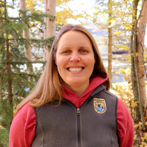 smiling woman in a USFWS vest