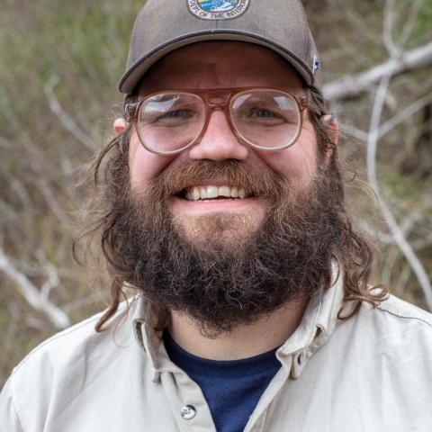 person with beard wearing hat with USFWS logo