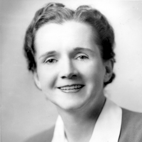 black and white headshot of smiling woman
