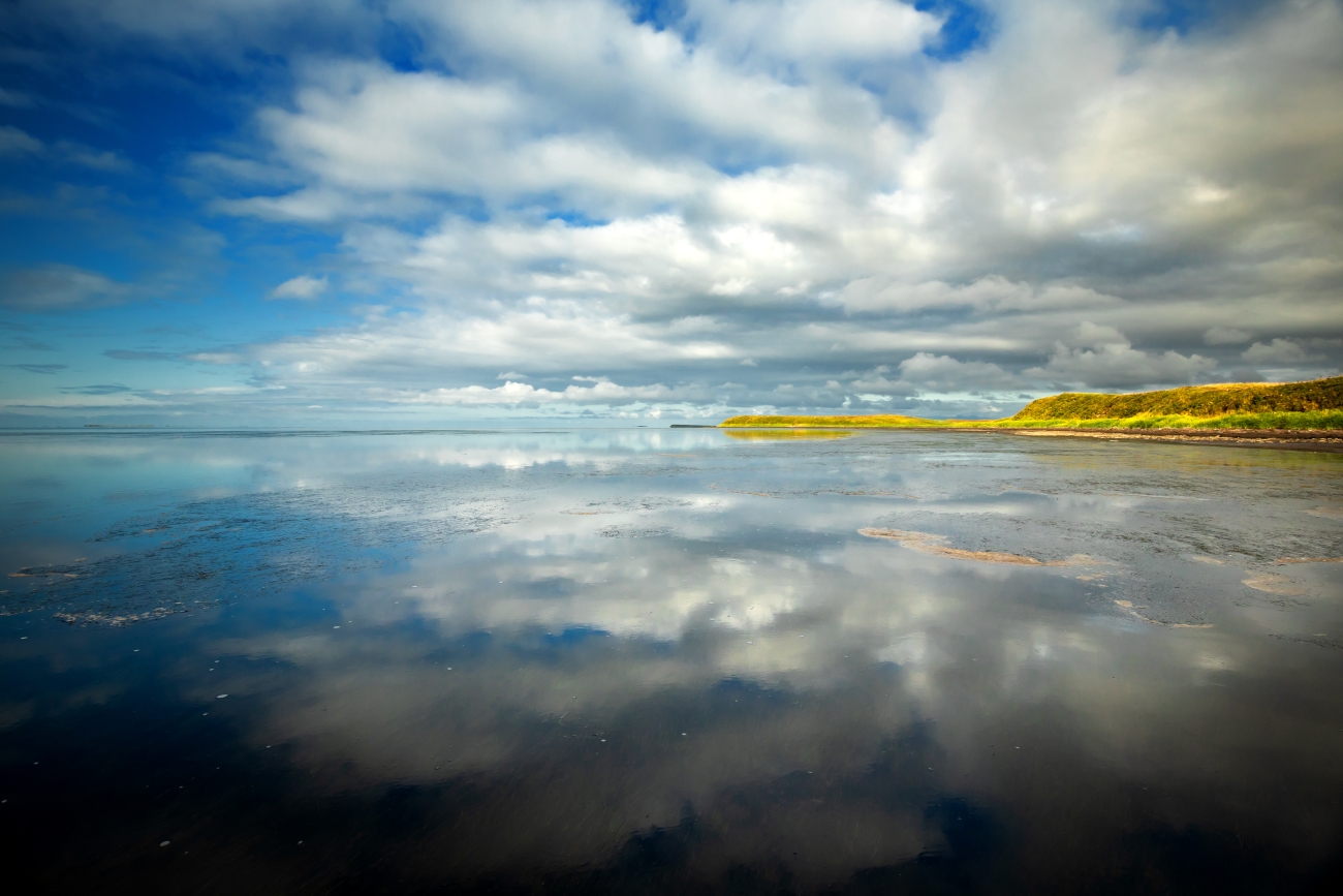 Reflection of clouds over calm water of Izembek Lagoon | FWS.gov