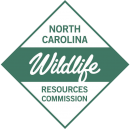 Diamond shaped figure with the words "North Carolina Wildlife Resources Commission" inside.
