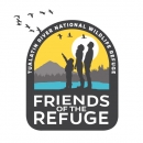 Logo for the Friends of Tualatin River National Wildlife Refuge Complex; image shows three people looking up at a flock of birds; background yellow and blue with mountains and water