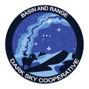 Round logo featuring a bighorn sheep in the desert, with stars in a dark sky above