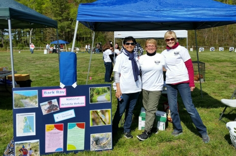 Volunteers staffing a table for Back Bay NWR at a special event
