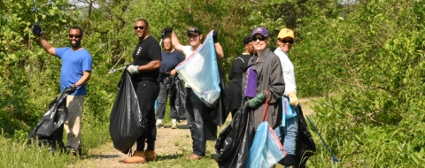 A group poses for a photo while picking up litter at Occoquan Bay NWR