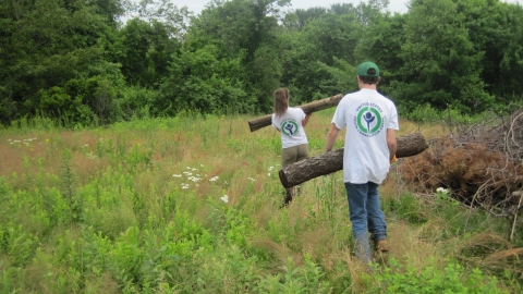 Youth Conservation Corps team members clearing brush