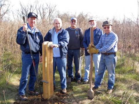 Several volunteers stand around a recently installed post at Ohio River Islands National Wildlife Refuge in West Virginia
