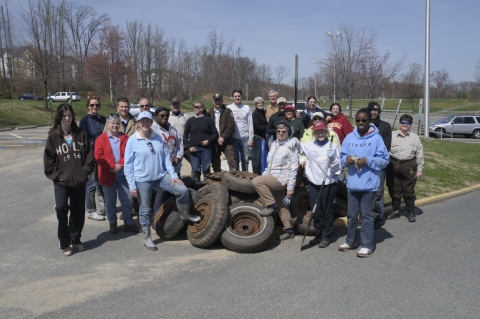 A large group posing for a photo after helping clean trash at Featherstone NWR.