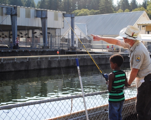 Williard National Fish Hatchery employee Pat Cushman assists with Kid's Fishing Day 2015