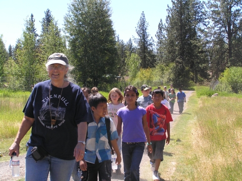 A Refuge volunteer leads a group of students back from a nature hike at Turnbull NWR