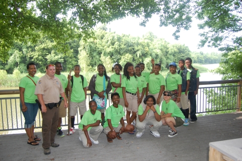 Field trip of schoolchildren, their teacher, and a USFWS employee smiling