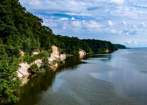 tree-covered cliffs line the bright blue Rappahannock River