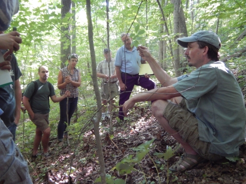 people in the woods gather around Dr. Burkhart