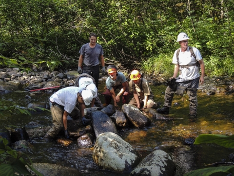a crew works in a stream
